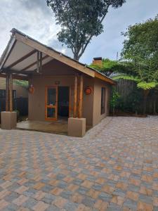 a house with a brick driveway in front of it at Dar Amane Guest House in Graskop