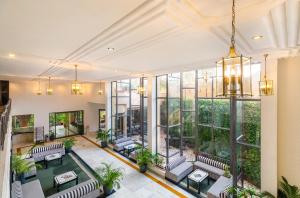 an indoor lobby with couches and windows at Rajdarshan - A Lake View Hotel in Udaipur in Udaipur