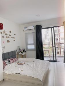 a bedroom with a bed and a large window at Topaz twin in Bien Hoa