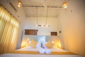 Voodi või voodid majutusasutuse Aki Luna Lagoon Resort Hikkaduwa toas