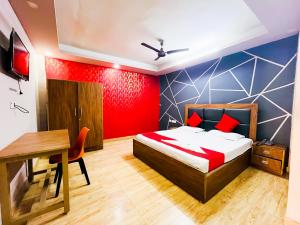 a bedroom with a bed and a table and a desk at Sunrise Haven Near Nizamuddin Railway Station 2 Min Walk in New Delhi