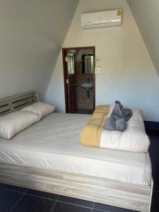 a bedroom with two beds in a room with at Nam Hu Camping น้ำฮูแคมป์ปิ้ง in Chiang Dao