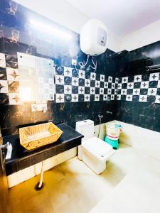 a bathroom with a sink and a toilet at Sunrise Haven Near Nizamuddin Railway Station 2 Min Walk in New Delhi