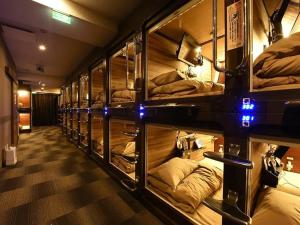a row of bunk beds in a room at Anshin Oyado Premier Nagoya Sakae in Nagoya