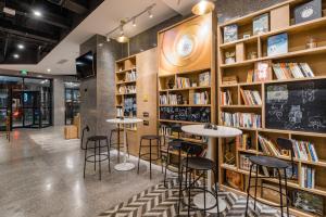 a bookstore with tables and shelves of books at Atour Light Hotel Temple of Heaven in Beijing