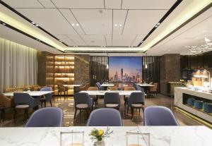 a rendering of a restaurant with tables and chairs at Atour Hotel Guangzhou Baiyun New Town Jiangxia Metro Station in Guangzhou