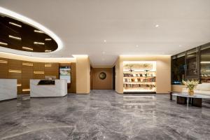 a lobby with a reception desk and a lobby at Atour Hotel Xi'an Bell Tower Dacha City Metro Station in Xi'an