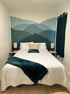 a bedroom with a large bed with a painting on the wall at KarKens Container Home in Salmon