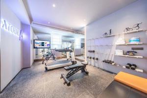 a gym with three treadmills and bikes in a room at Atour Hotel Kunming Railway Station Joy City in Kunming