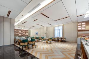 a dining room with tables and chairs in a cafeteria at Atour Hotel Foshan Chancheng Zhangcha in Foshan