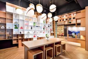 a dining room with a table and shelves at Atour Hotel Chengdu Jinli Hongpailou Subway Station in Chengdu