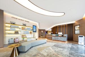 a lobby of a hotel with a waiting area at Atour Hotel Xiamen Xiang'an Torch Industrial Park in Xiang'an