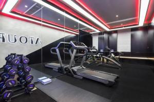 a gym with a treadmill and elliptical machines at Atour Hotel Zhijiang Bridge in Hangzhou