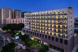 a building with a hotel sign on top of it at Atour Hotel Shenzhen Baoan Xixiang in Bao'an