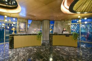 a lobby with two people on their laptops at Atour Hotel Wangjing SOHO in Beijing