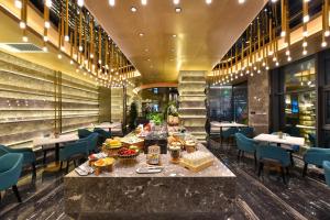 a restaurant with a table with food on it at Atour Hotel Wangjing SOHO in Beijing