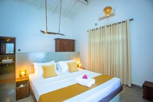 Voodi või voodid majutusasutuse Aki Luna Lagoon Resort Hikkaduwa toas