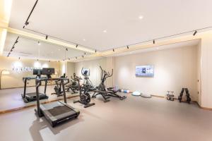 a gym with treadmills and exercise bikes in a room at Atour X Hotel Beijing Haidian Sijiqing in Beijing