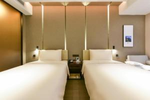 Postel nebo postele na pokoji v ubytování Atour Hotel Wangjing SOHO