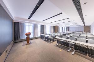 a large room with rows of chairs and a podium at Atour Hotel Kunming Xiaokang Avenue in Kunming