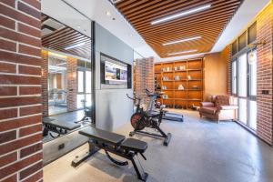 a gym with two exercise bikes and a brick wall at Atour X Hotel Beijing Daxing Airport Wildlife Park in Daxing