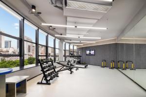 a gym with chairs and tables and large windows at Atour Light Hotel Hangzhou West Lake Wulin Plaza North Huancheng Road in Hangzhou