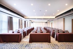 a large room with rows of tables and chairs at Atour Hotel Bantian Zhongcheng Shenzhen in Longgang