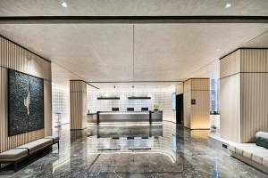 a lobby of a building with couches and a lobby at Atour Hotel Kunming Dianchi Park 1903 in Kunming