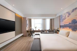 a large living room with a large flat screen tv at Atour Hotel Xi'an Daming Palace in Xi'an