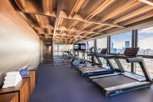 a gym with a row of treadmills and machines at Atour S Hotel Shenzhen Luohu Clams in Shenzhen