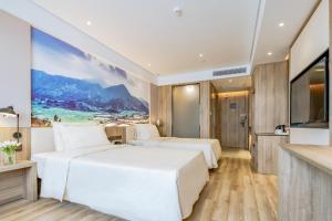 Ένα ή περισσότερα κρεβάτια σε δωμάτιο στο Atour Hotel Huizhou Huiyang High-speed Railway Station