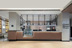 two people sitting at a counter in a restaurant at Atour X Hotel Shanghai Xujiahui Sports Center in Shanghai