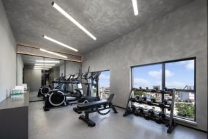 a gym with treadmills and ellipticals and a large window at Atour Light Hotel Guangzhou East Fuhua Road Panyu Plaza in Guangzhou