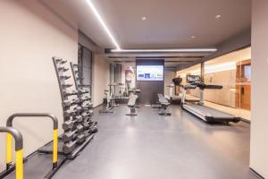 a gym with treadmills and machines in a room at Atour Hotel Shenzhen Futian CBD Civic Center in Shenzhen