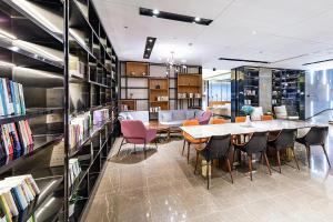 a library with a table and chairs and books at Atour Hotel Shenzhen Baoan Xixiang in Bao'an