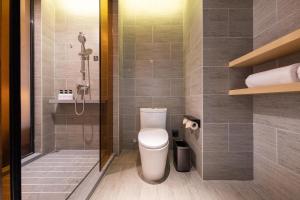 a bathroom with a toilet and a shower at Atour Hotel Shanghai Caohejing in Shanghai