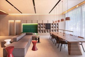 a dining room with a long table and chairs at Atour Hotel Shanghai Caohejing in Shanghai