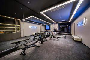 a gym with several treadmills and machines in it at Atour Hotel Chongqing Nan'an Tea Garden New Area in Chongqing
