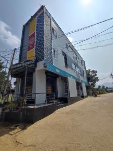 a large building with a sign on the side of it at Sri Aksha Residency in Alāndurai