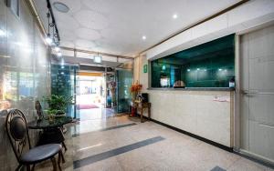 a lobby with a counter and a table and chairs at Hyatt Motel in Suncheon