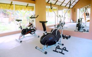 a gym with three exercise bikes in a room at Coco Village Hotel Chilaw in Chilaw