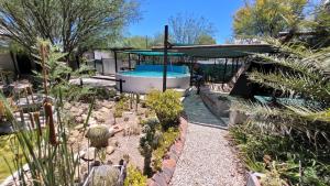 a garden with a swimming pool and some plants at Aberdeen Self Catering in Aberdeen