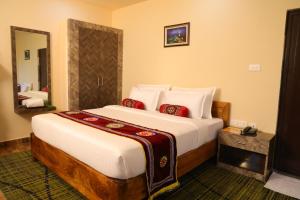 a bedroom with a large bed in a room at Hotel Silicon Residency Puri Excellent Service Awarded - Parking & Lift facilities in Puri