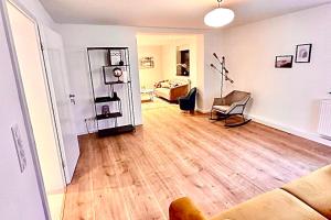 a living room with a couch and a hard wood floor at Beautiful House in Salzweg in Salzweg