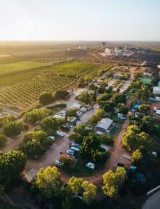 an aerial view of a parking lot with trees at Capricorn Holiday Park in Carnarvon