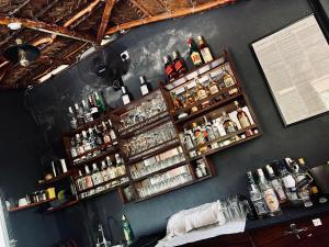 een bar met flessen alcohol aan de muur bij Coco Village Hotel Chilaw in Chilaw
