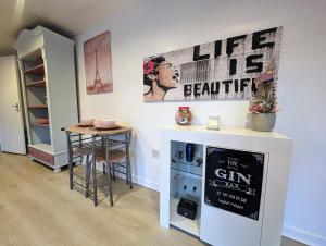 a room with a table and a sign on the wall at The Cabin in Bonnybridge