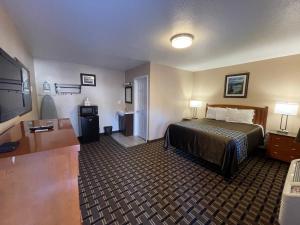 a hotel room with a bed and a flat screen tv at Tahoe Hacienda Inn in South Lake Tahoe