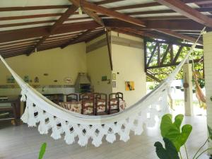 a hammock in the living room of a house at Casa de campo, perto da praia in Lucena