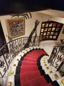 a spiral staircase with a red and black rug at Q Hotel in Beirut